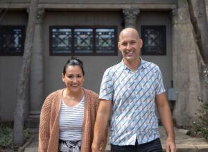 PIcture Jess Lenouvel and Husband Smiling and Holding Hands While Walking Towards the Camera | Email Marketing for Realtors | The Listings Lab