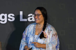 Jess Lenouvel Smiling To Her Audience While Speaking at one of her TLL Live Real Estate Agents Events | The Listings Lab |