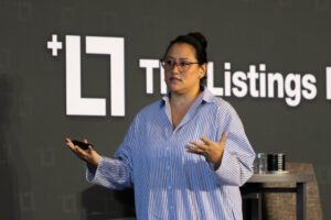 Picture of Jess Lenouvel Speaking to Her Audience at a Live The Listings Lab Event | Real Estate Mindset Differences